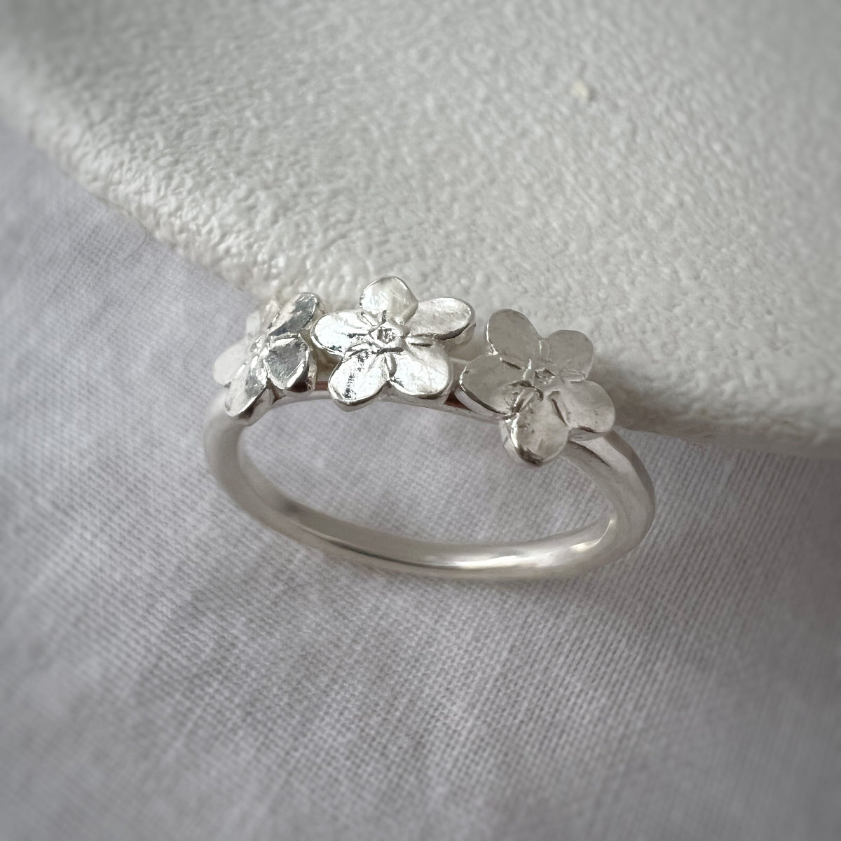 Three Silver Forget Me Not Flowers on Silver Band with White Background