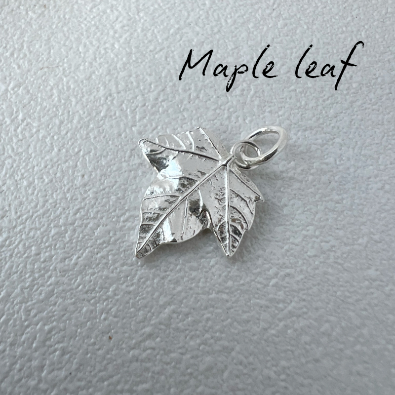 Silver maple leaf pendant on a light gray background with 'Maple leaf' text.