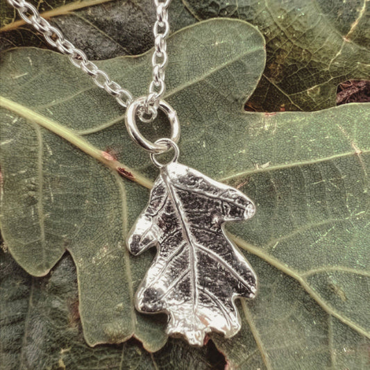Silver Oak Leaf Necklace on green oak leaves