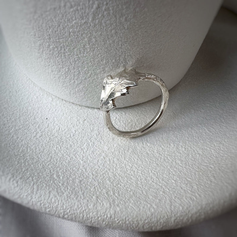 Silver oak leaf ring on white plate