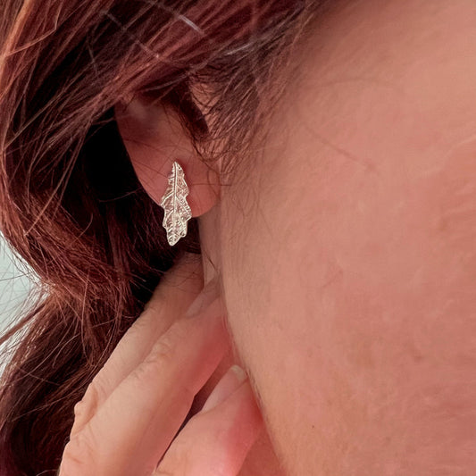 Close up of wearing Oak Leaf studs