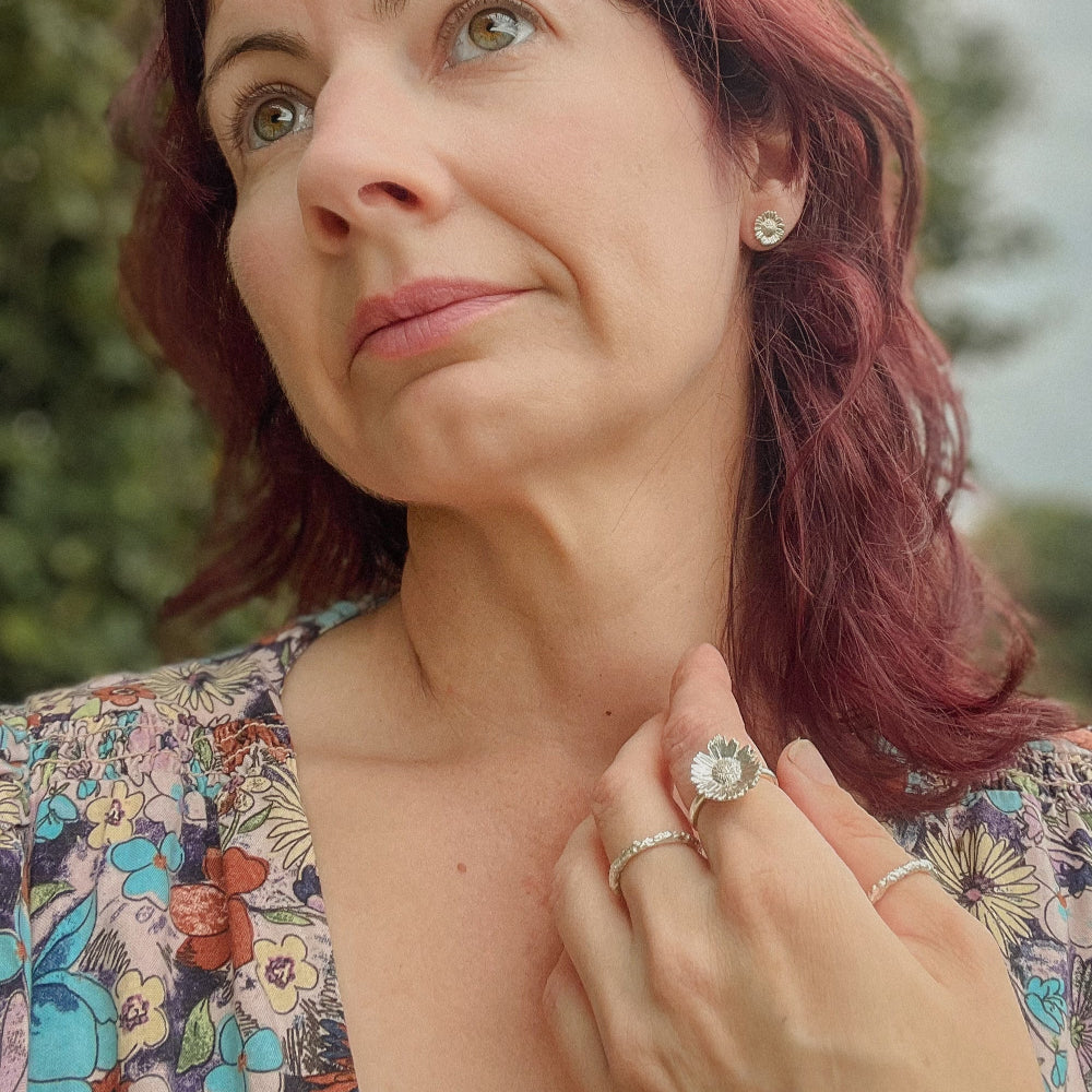 Holding Large Daisy Flower Wearing Silver Daisy Ring
