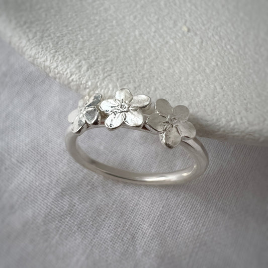Three Silver Forget Me Not Flowers on Silver Band with White Background