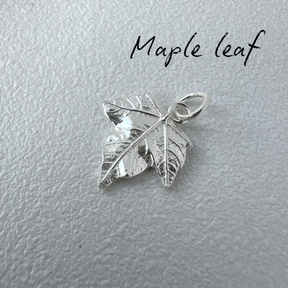 Silver maple leaf pendant on a light gray background with 'Maple leaf' text.