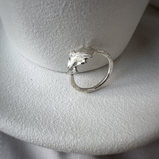 Silver oak leaf ring on white plate