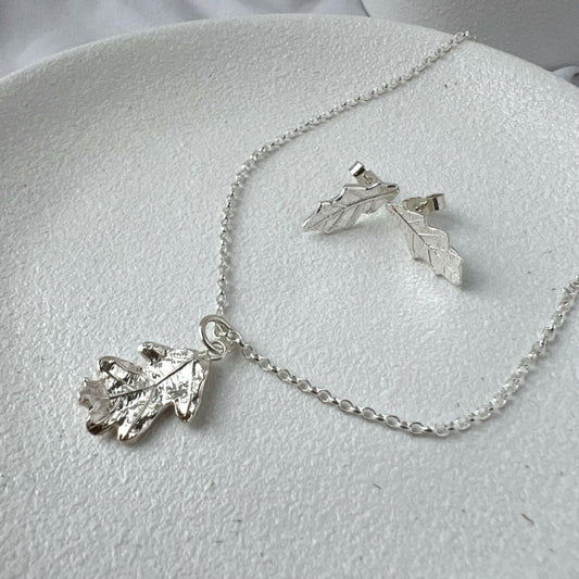 Silver Oak Leaf Pendant and Stud Earrings on White Plate