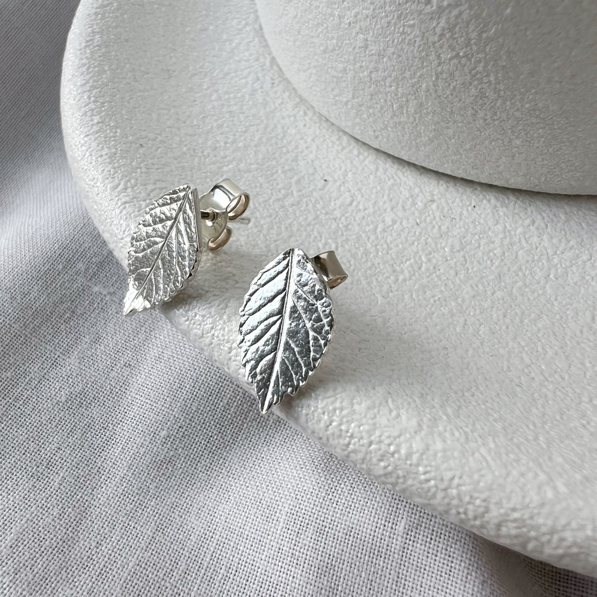 Silver Leaf Earrings on White Plate